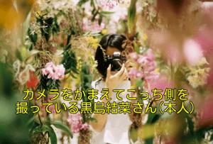黒島結菜がお花畑で写真を構えてこっち側を撮ってる画像